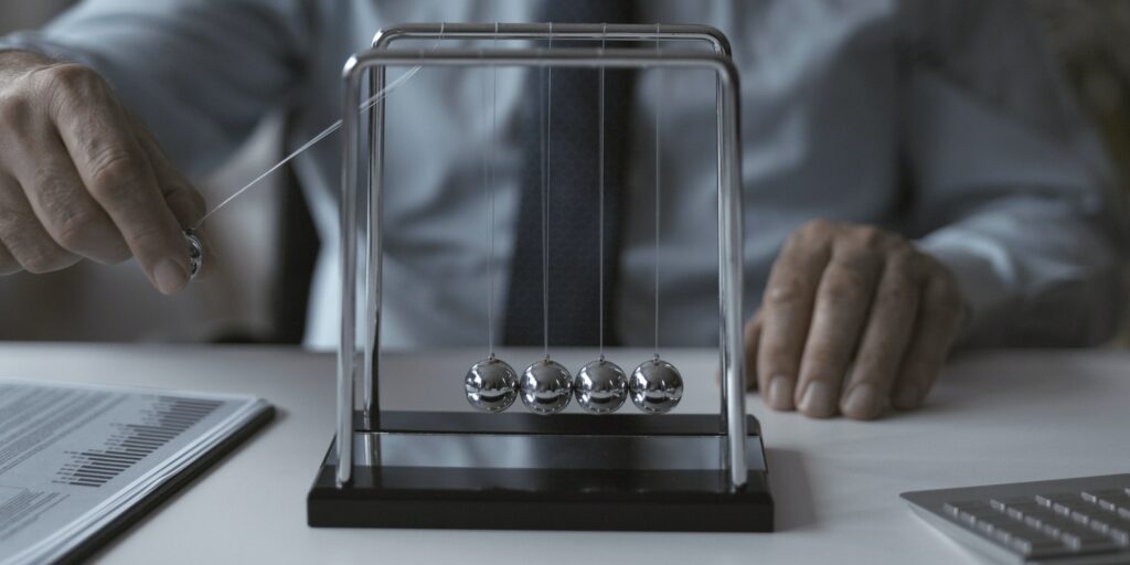 Corporate businessman and Newton's cradle