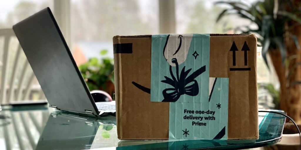 Delivered Amazon online order box next to laptop on a table