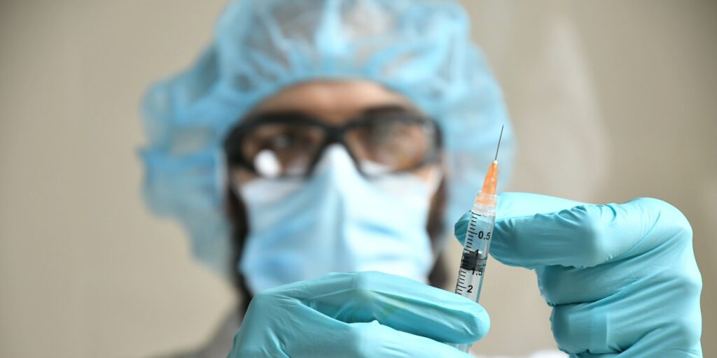 Dr. holding the syringe