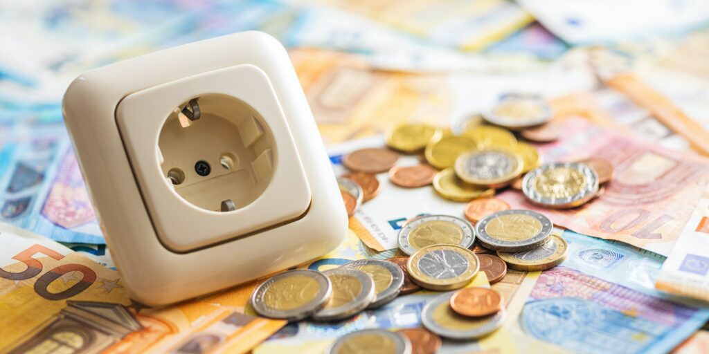 Electric socket and euro money. Concept of increasing electricity prices.