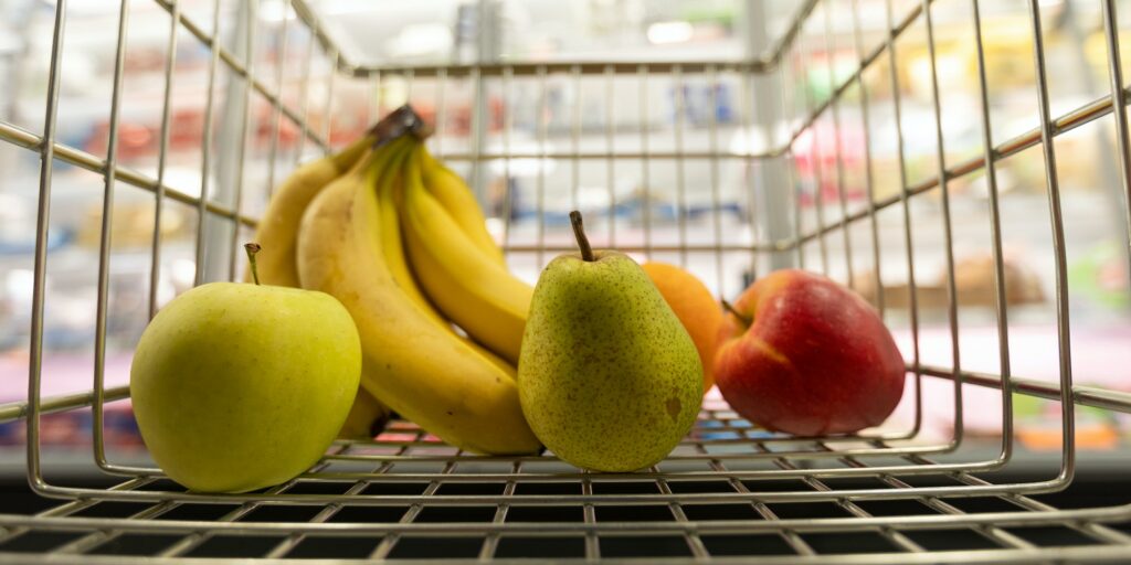 Fruits inside in trolley in supermarket, Inflation and economic recession concept.