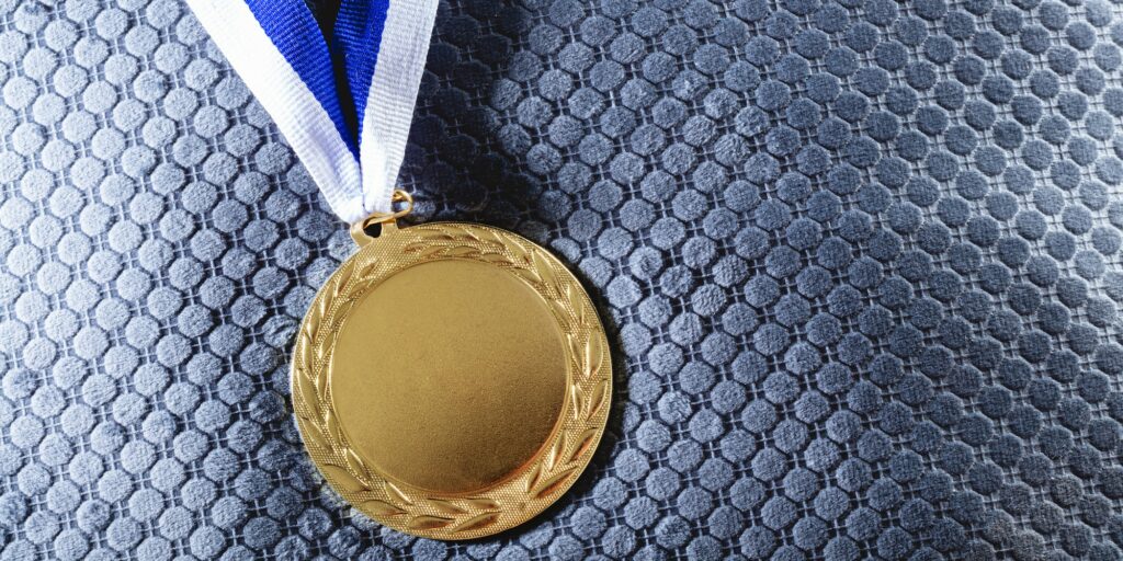 Gold medal on velvet cushion. Olympic games