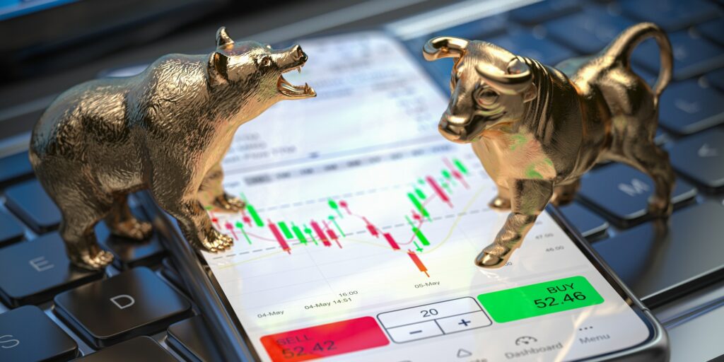 Golden bull and bear as symbols of stock market on a smartphone