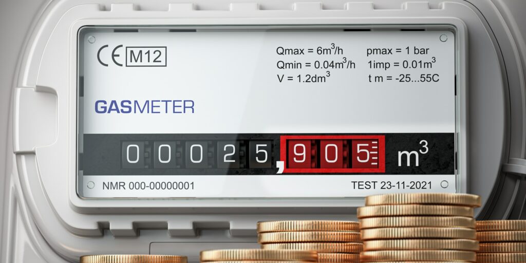 Growth of natural gas price. Gas meter with stacks of coins.