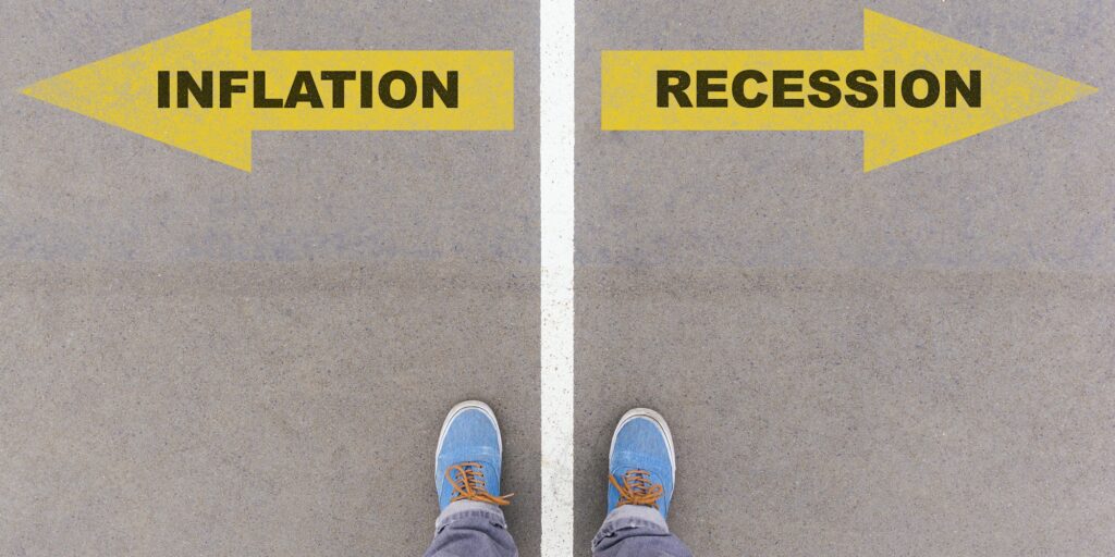 Inflation or recession choice, text on asphalt ground, feet and shoes on floor