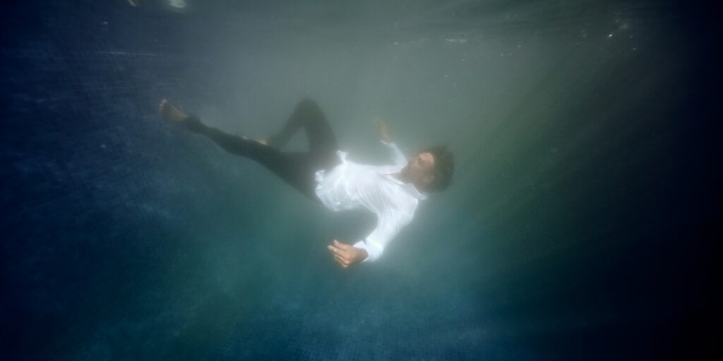 Man drowning in swimming pool