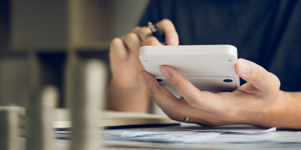 Man use calculators and documents that calculate expenses in the home office.