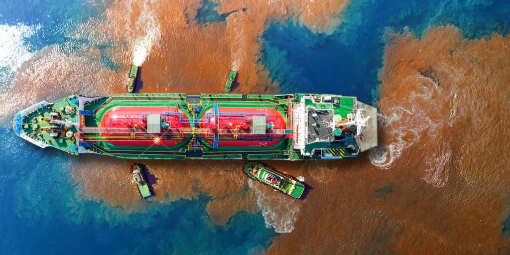 Oil leak from Ship , Oil spill pollution polluted water surface. water pollution as a result