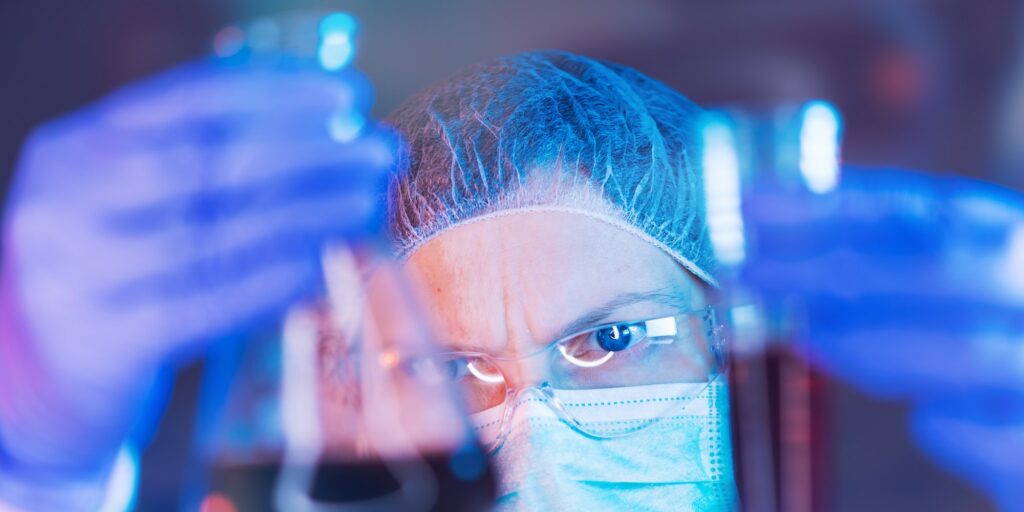 Scientist working with chemicals in laboratory