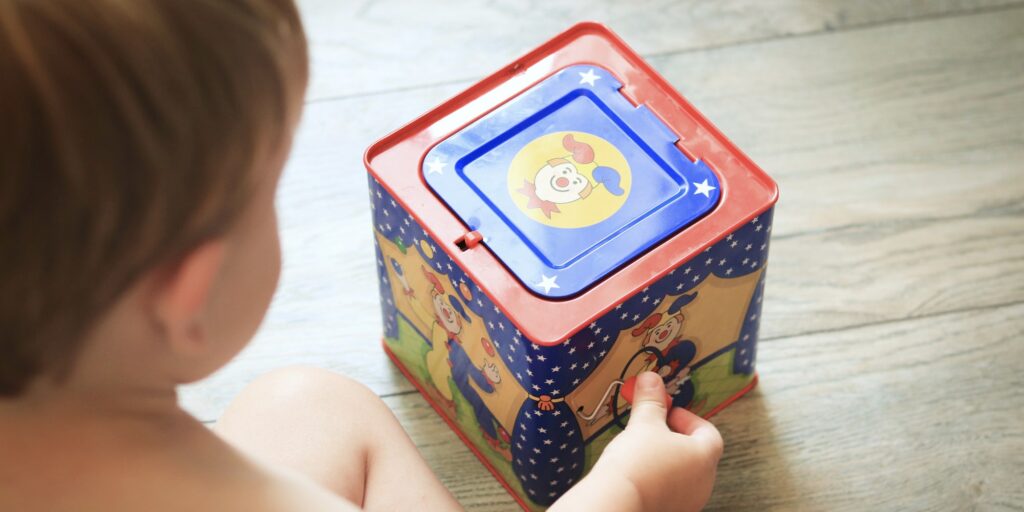 Small Boy Playing With Jack In the Box