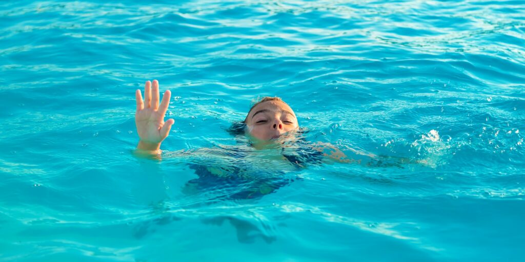 The child is drowning in water. Selective focus.