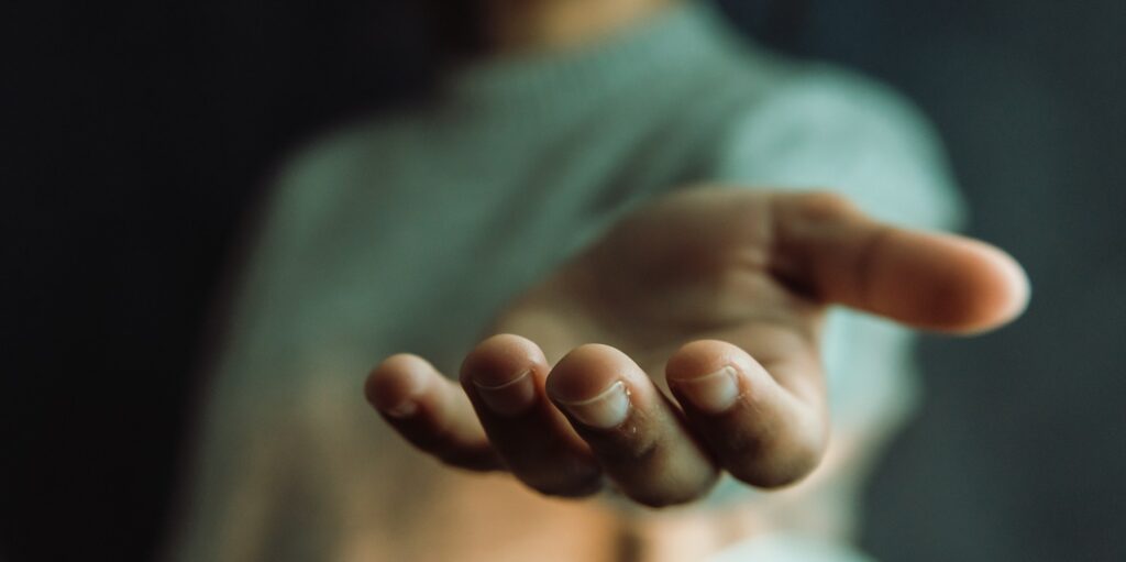 Woman giving hands to the camera, help and self help concept, mental health