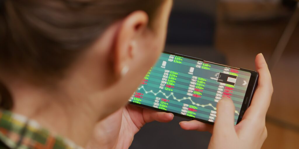 Back view of woman checking stock trading