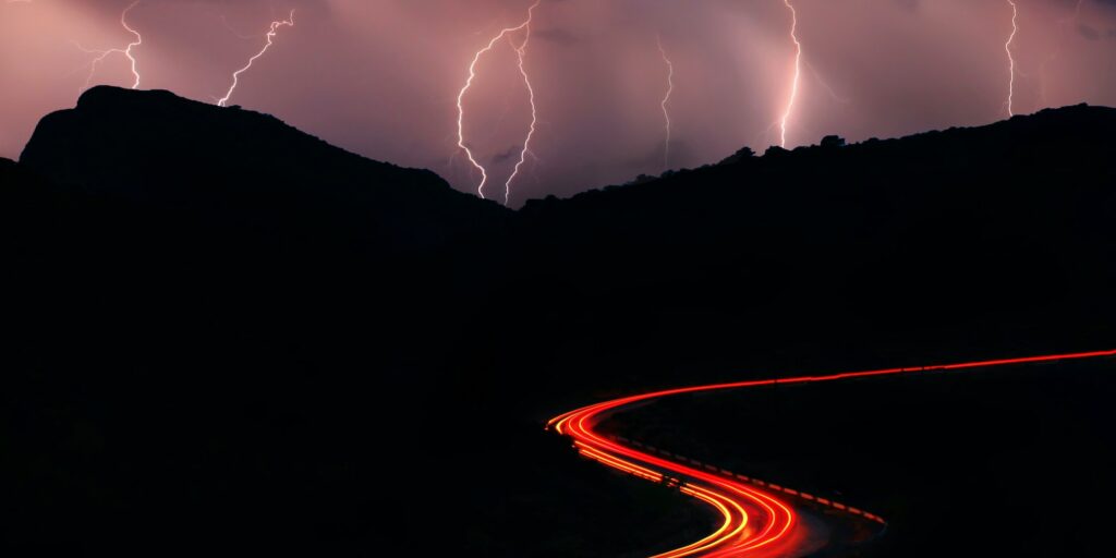 Night roads in the mountains with a stream of cars