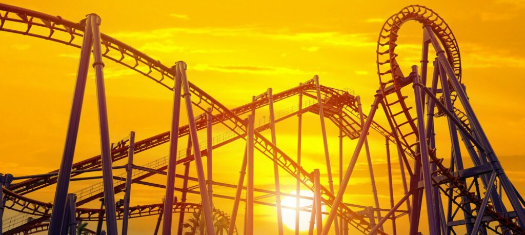 Roller coaster in the amusement park with the sunset background.
