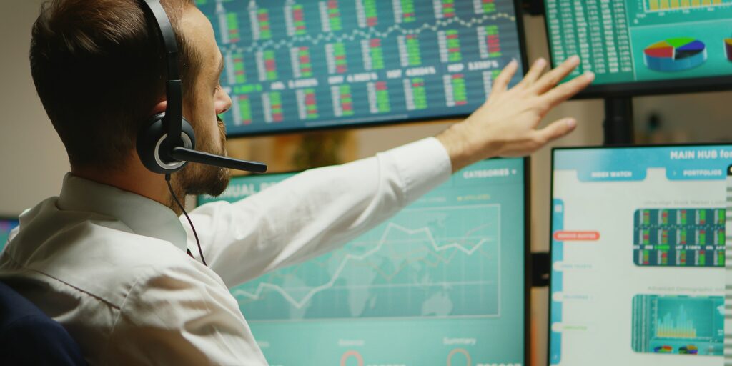 Broker with headphones checking the stock market