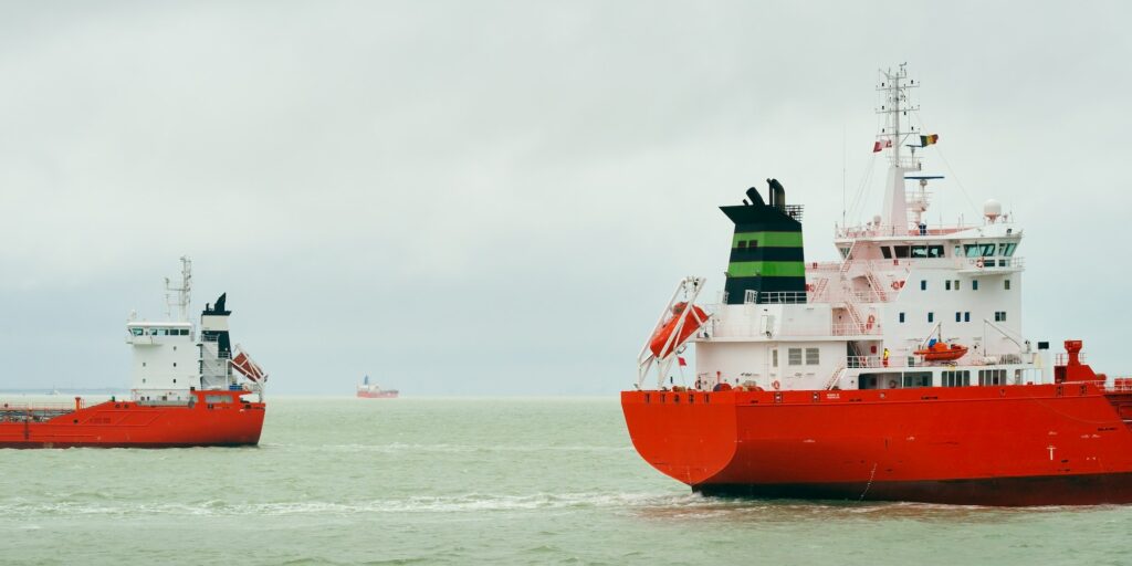 Ships with red hull pass each other on the North Sea