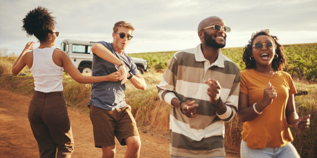 Freedom, travel and dance with friends on road trip in countryside for party, summer and celebratio