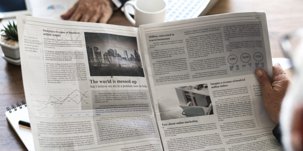 Business people reading newspaper