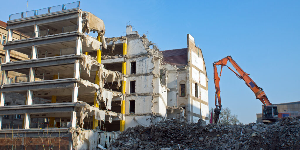 Demolition of a building with excavator