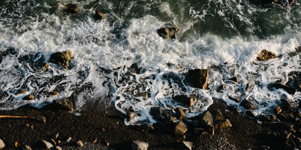 Top view of the sea. Waves, rocks. Beach.