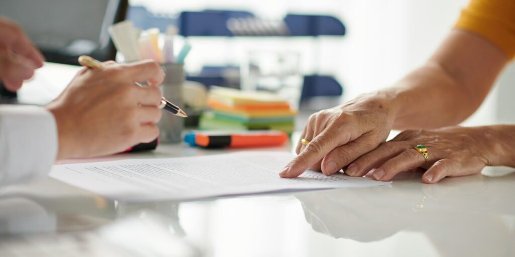 Senior Woman Signing Document