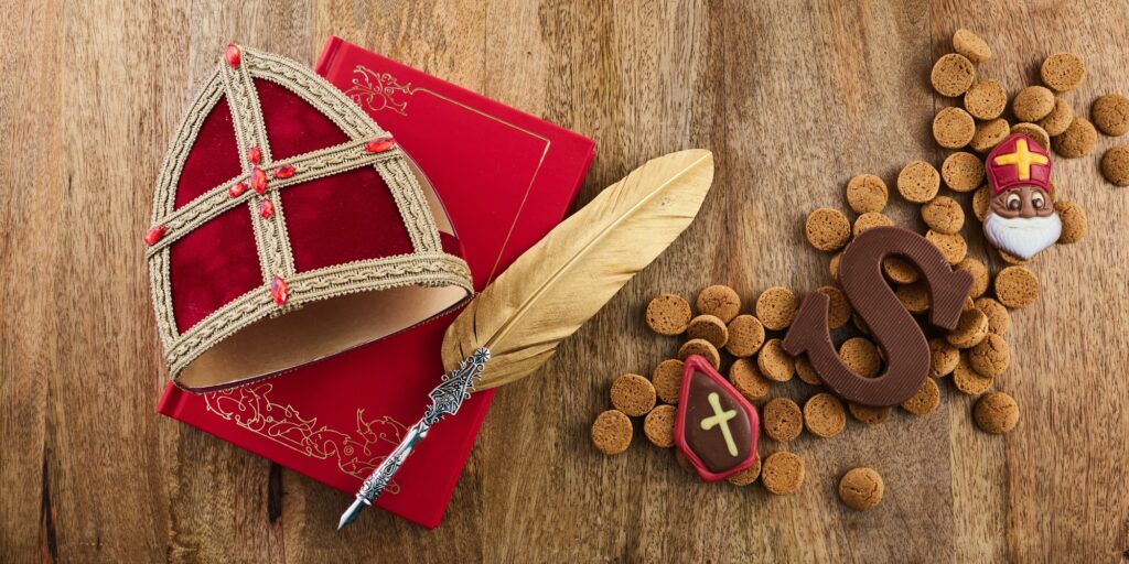 Dutch holiday Sinterklaas background with mitre or mijter staff and book of Sinterklaas.