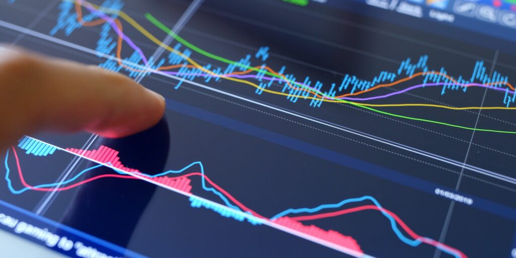 Finger touch on screen with stock market data