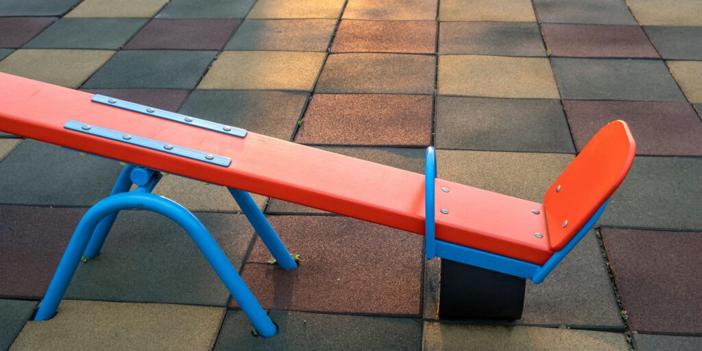 Rubber coating and flip flap swing at the playground at preschool.