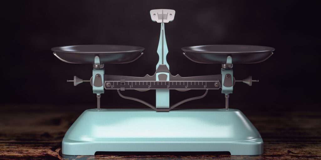 Balance scales on black background.
