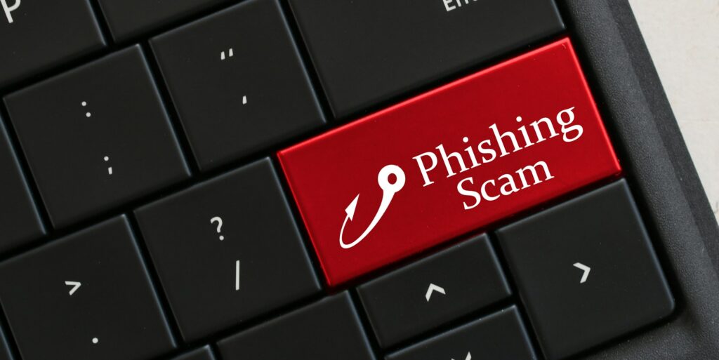 Beware of Phishing Scam Emails - Concept - Computer Keyboard with red key that says PHISHING SCAM
