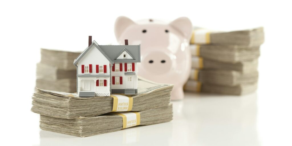 Small House and Piggy Bank with Stacks Money