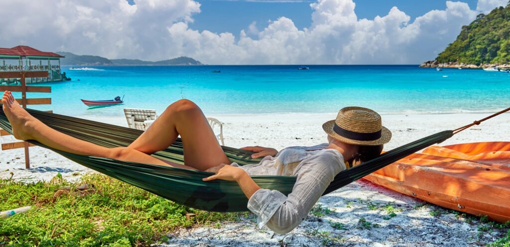 Woman in hammock on beach