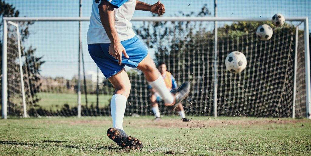 Sports, training and football player score a goal for challenge at a game or match at tournament. F