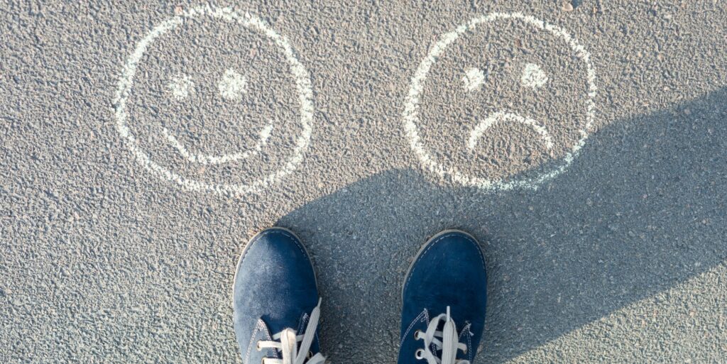 Happy Smileys or Unhappy, text on asphalt road