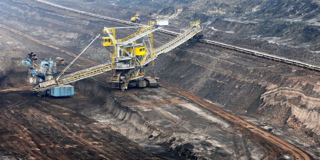 View into a coal mine with working wheel excavator