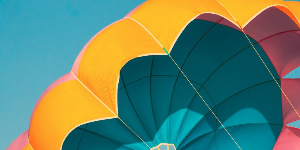 Close Multi-colored Parachute For Parasailing On Background Of Blue Sky