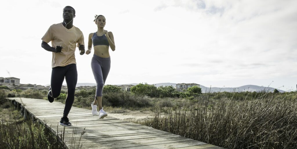 Couple jogging on wooden walkway