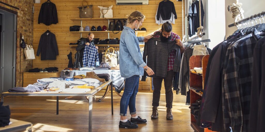 Friends choosing clothes in store