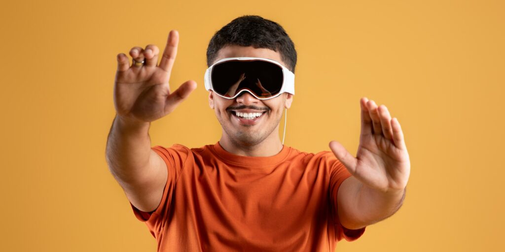 Modern imaging. Happy handsome brazilian man using modern vision pro glasses of virtual reality on