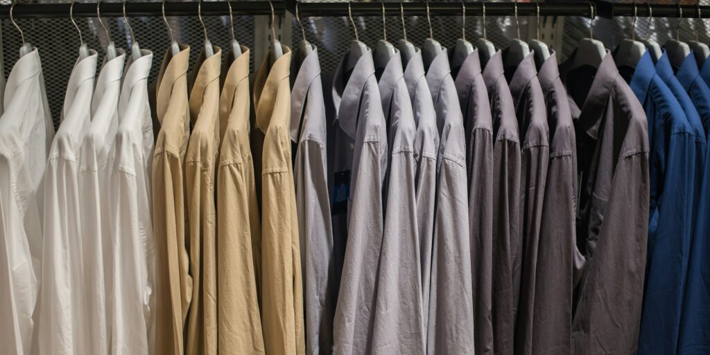 Shirt hanging on rail at Clothes shop.