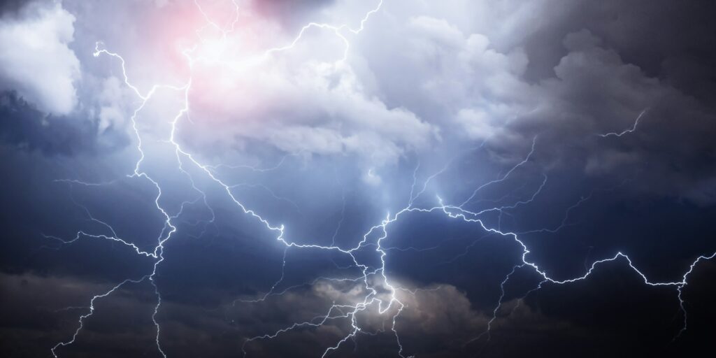 A dark cloudy sky with thunder lightning
