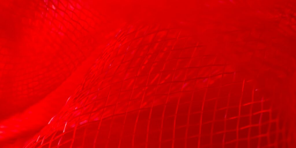 Bright red abstract grid netting waves background