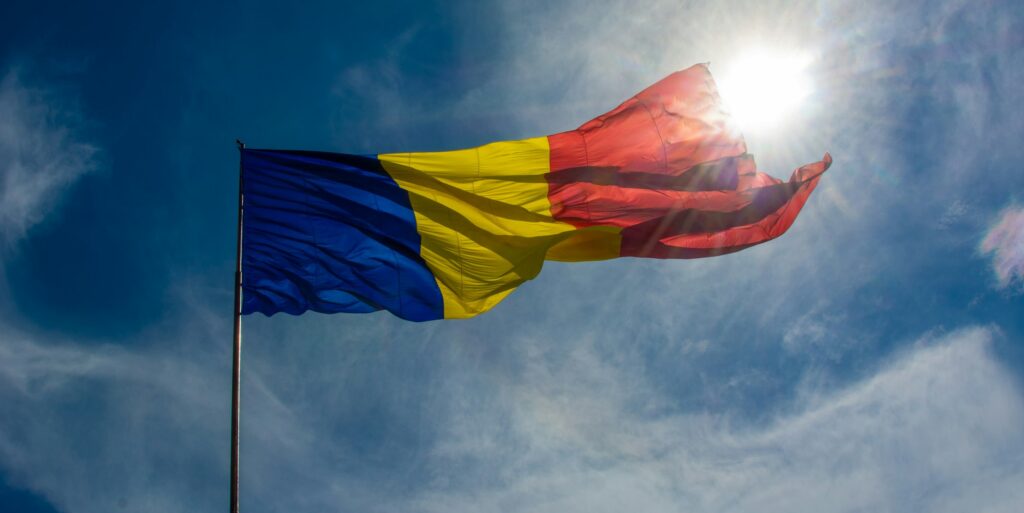 Flag of Romania on the flagpole waving in the wind