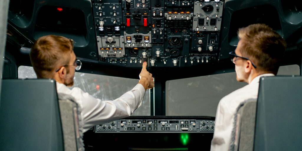 pilots in the cockpit of an airplane during flight control in turbulence zone flight simulator