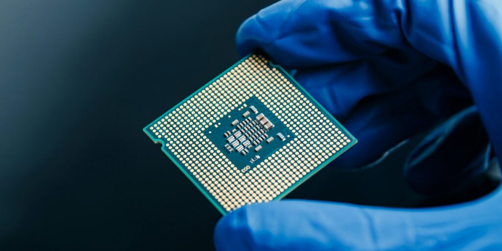 Semiconductor microchip in gloved hand