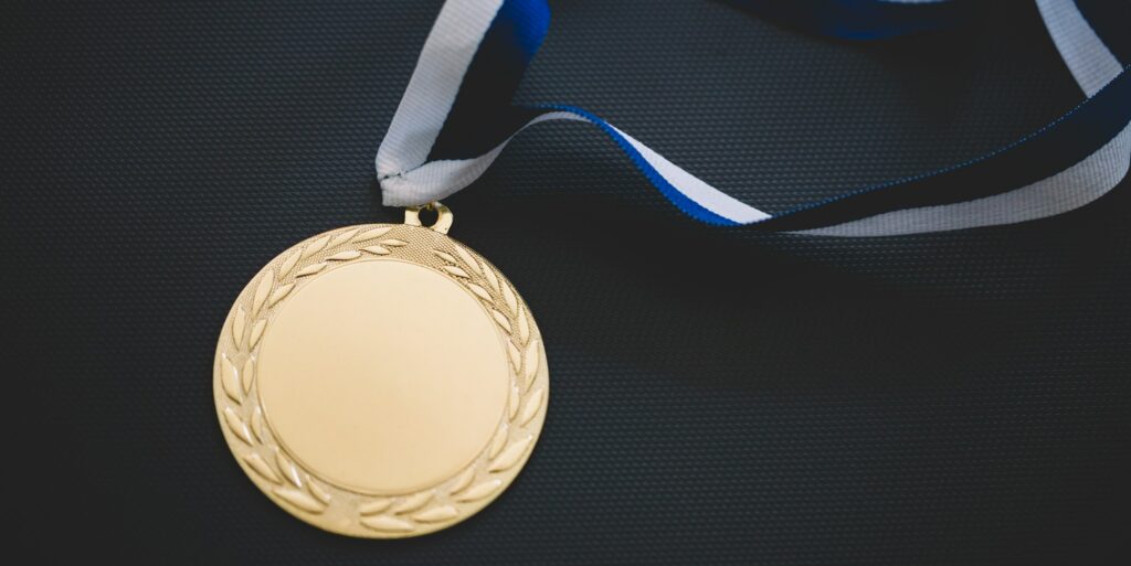 Gold medal on velvet cushion. Olympic games