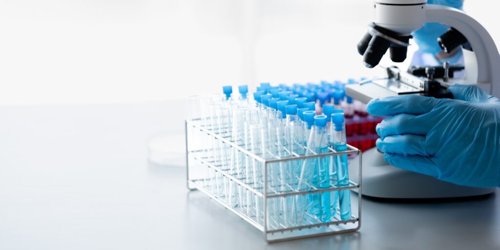 Lab practitioner working on chemical research for chemical reactions, does a chemical experiment and