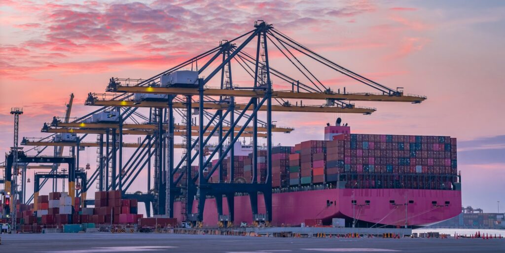 Cargo ship and truck at seaport waiting for container dock crane shipment harbour loading container