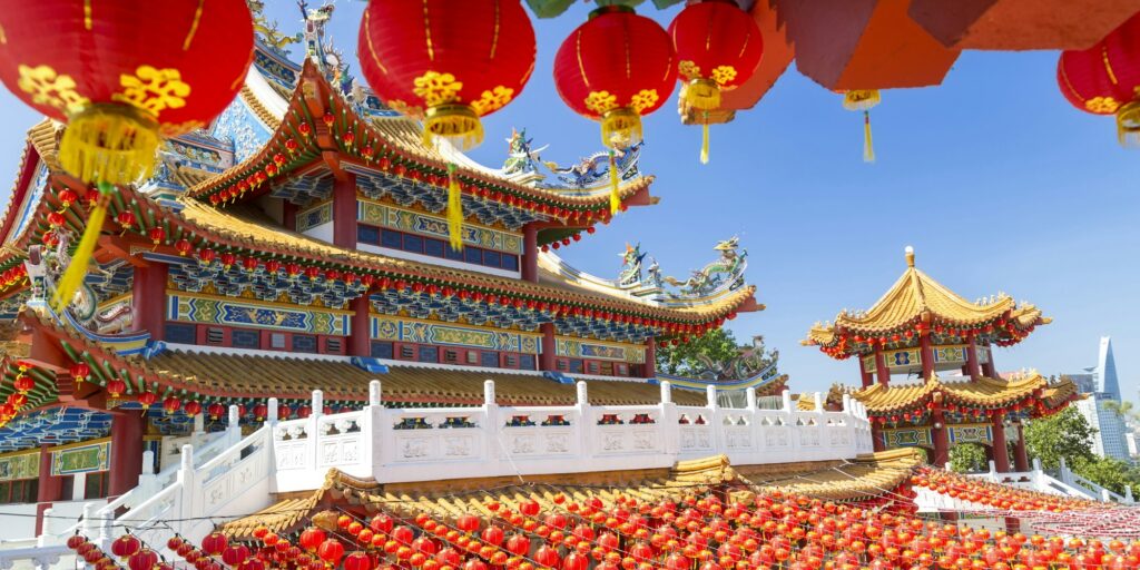 Colourful Chinese temple decorated with an abundance of traditional red paper lanterns.